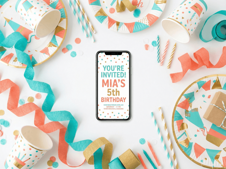 Coordinated birthday party supplies arranged around a phone showing a matching digital invite